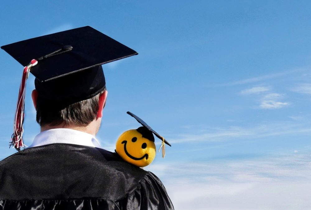 male-graduate-gazing-at-horizon-with-a-smiley-face-plushy-perched-on-shoulder-nominated_t20_eoB8vb